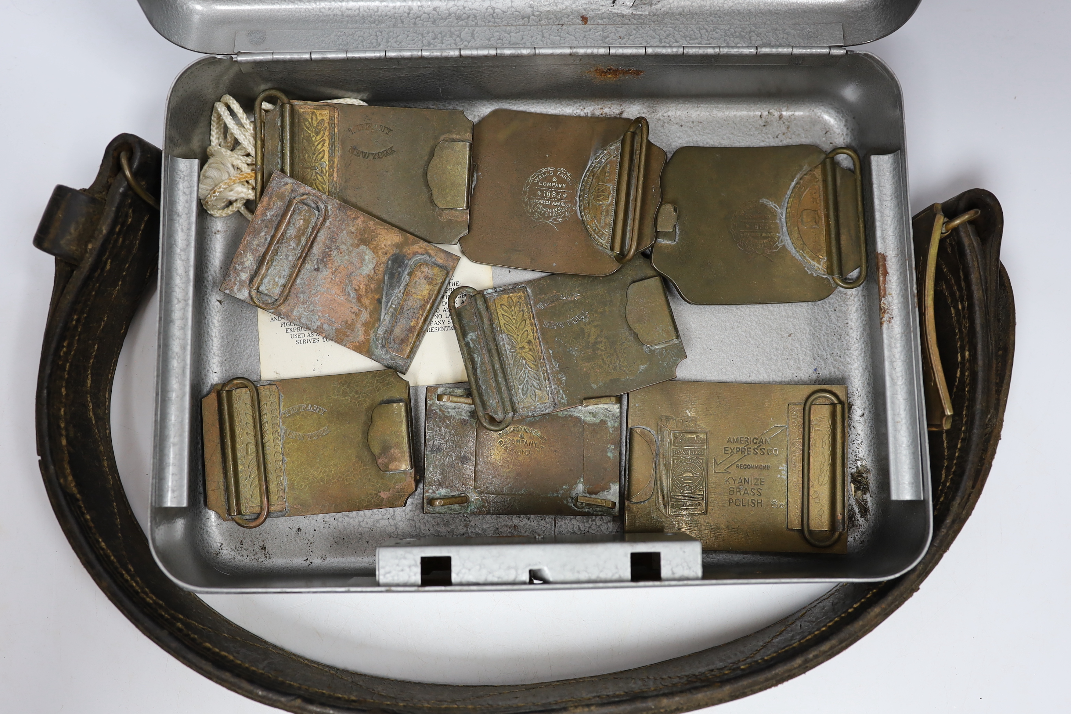 A collection of Wells Fargo and similar belt buckles by Tiffany & Co. Etc.